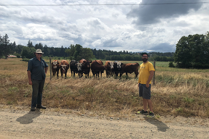 NIC Researcher Dr. Spencer Serin (right) and industry partner, Edgar Smith, visits cattle at Beaver Meadow farm