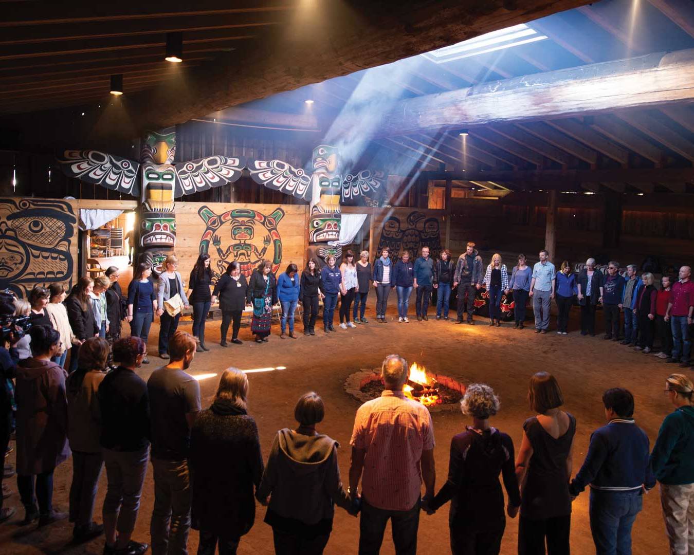 A group of NIC staff participate in cultural learning at the K'omoks First Nation