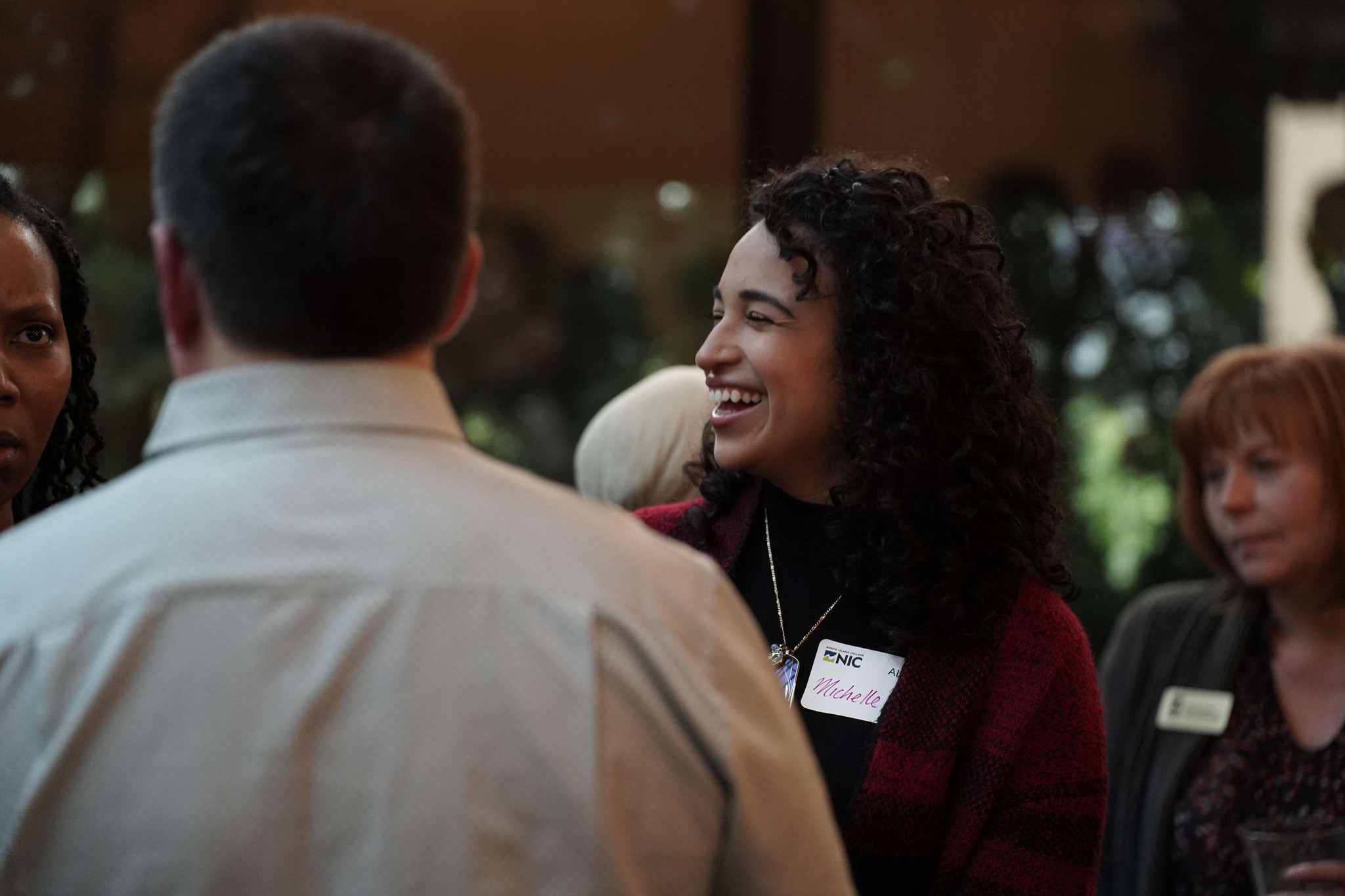 student smiling at alumni mixer