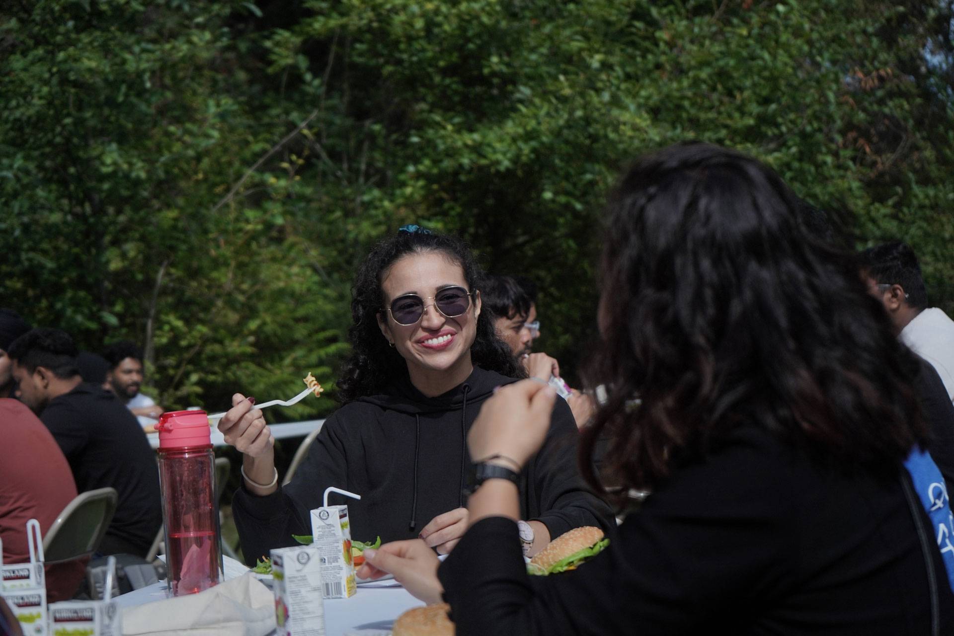 Students eating together outside at a campus event