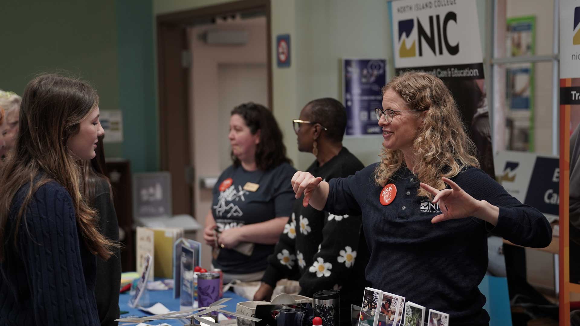 NIC Staff member shares information with an event attendee at an information fair