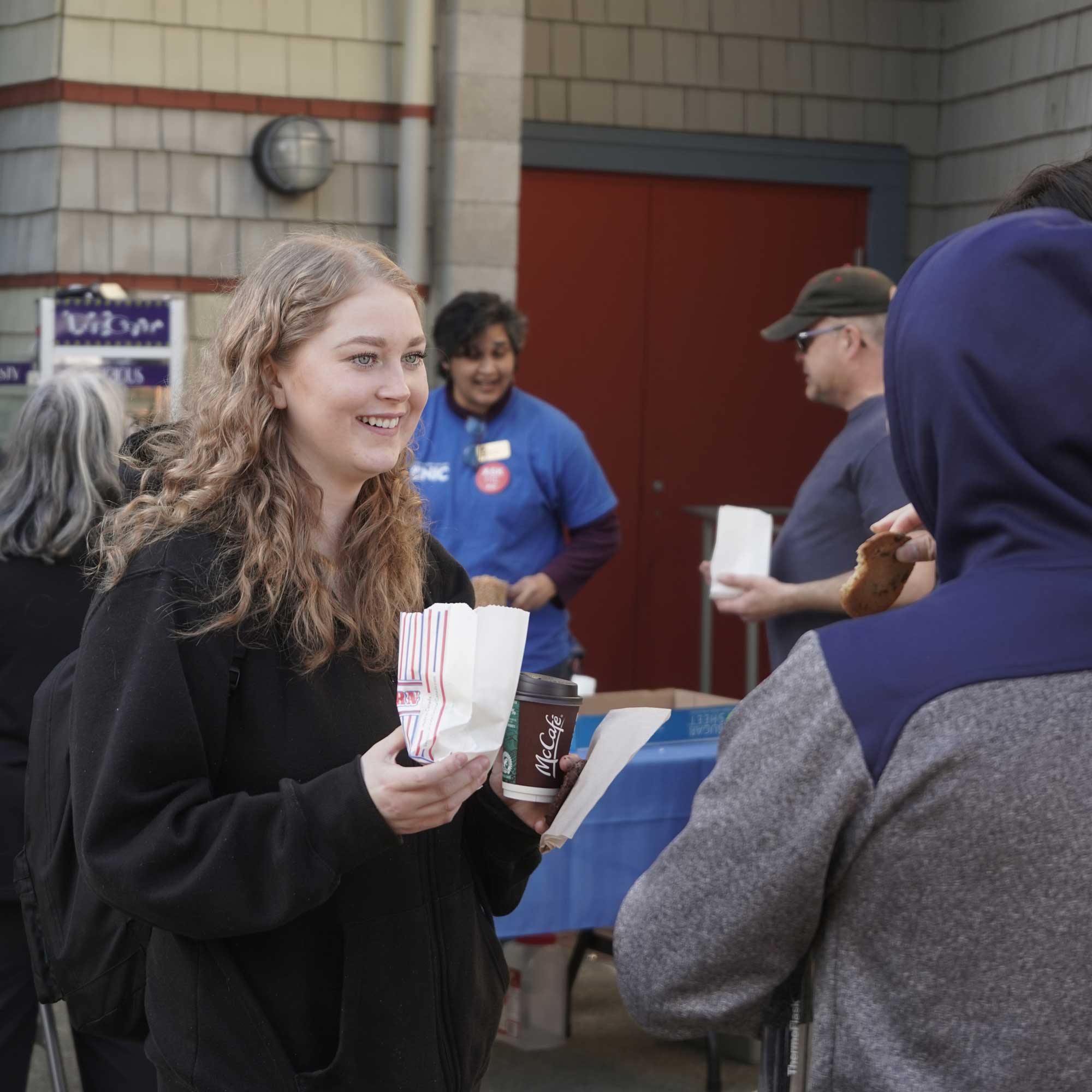 Students enjoying conversation while eating fresh popped popcorn at NIC Fest