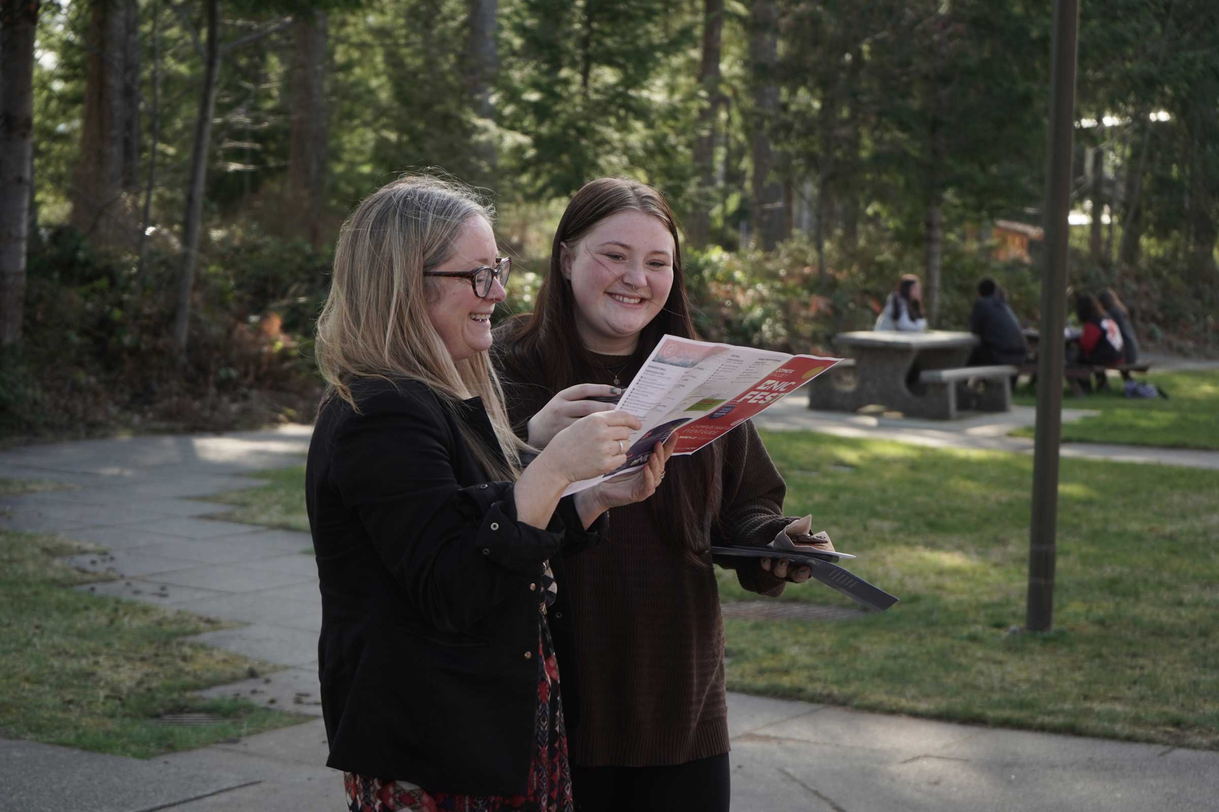 A parent and their future student browsing NIC Fest marketing materials while on campus