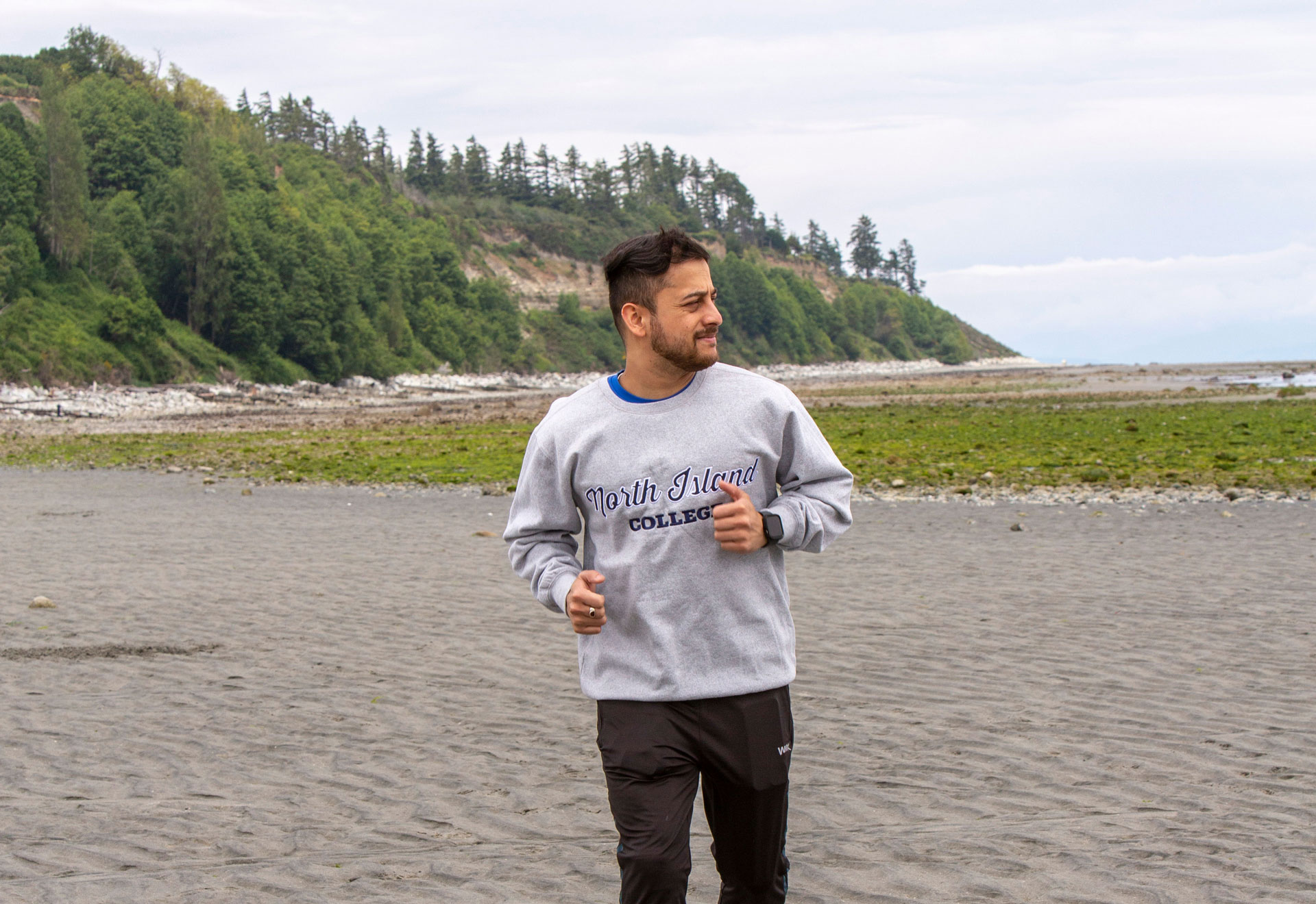 NIC student jogging at a Comox Valley beach.