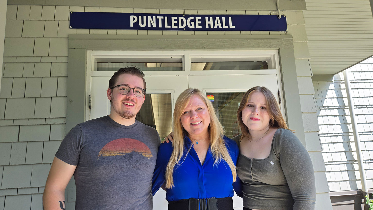 A mother and two children -- all nurses -- stand near their college
