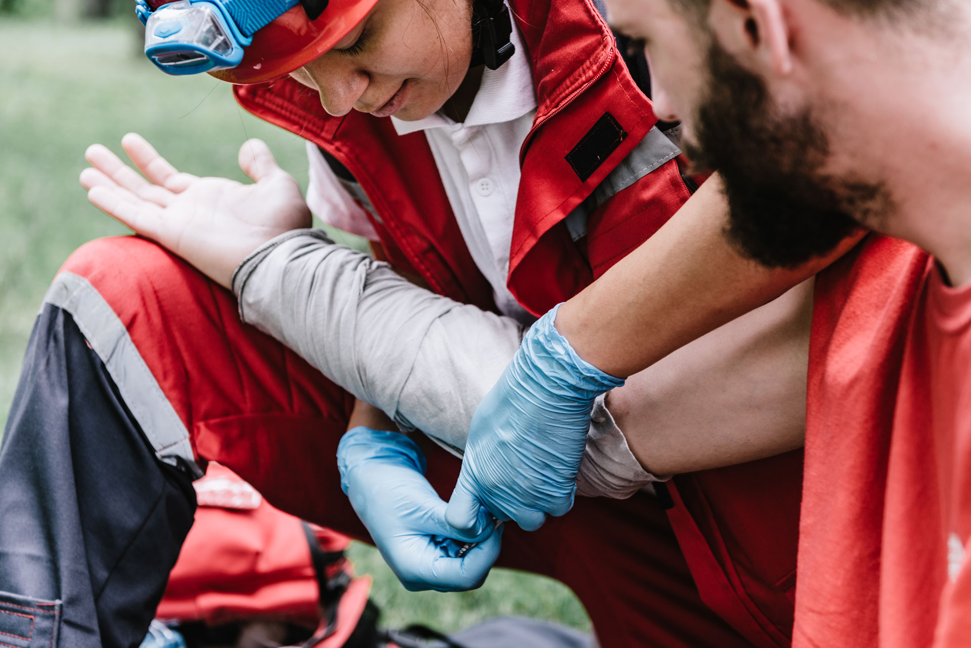 First aid attendant helping someone with an injured arm